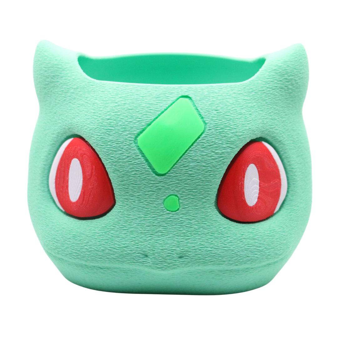 Bulbasaur Storage Bin with green textured surface and red eyes for desk or gaming room storage