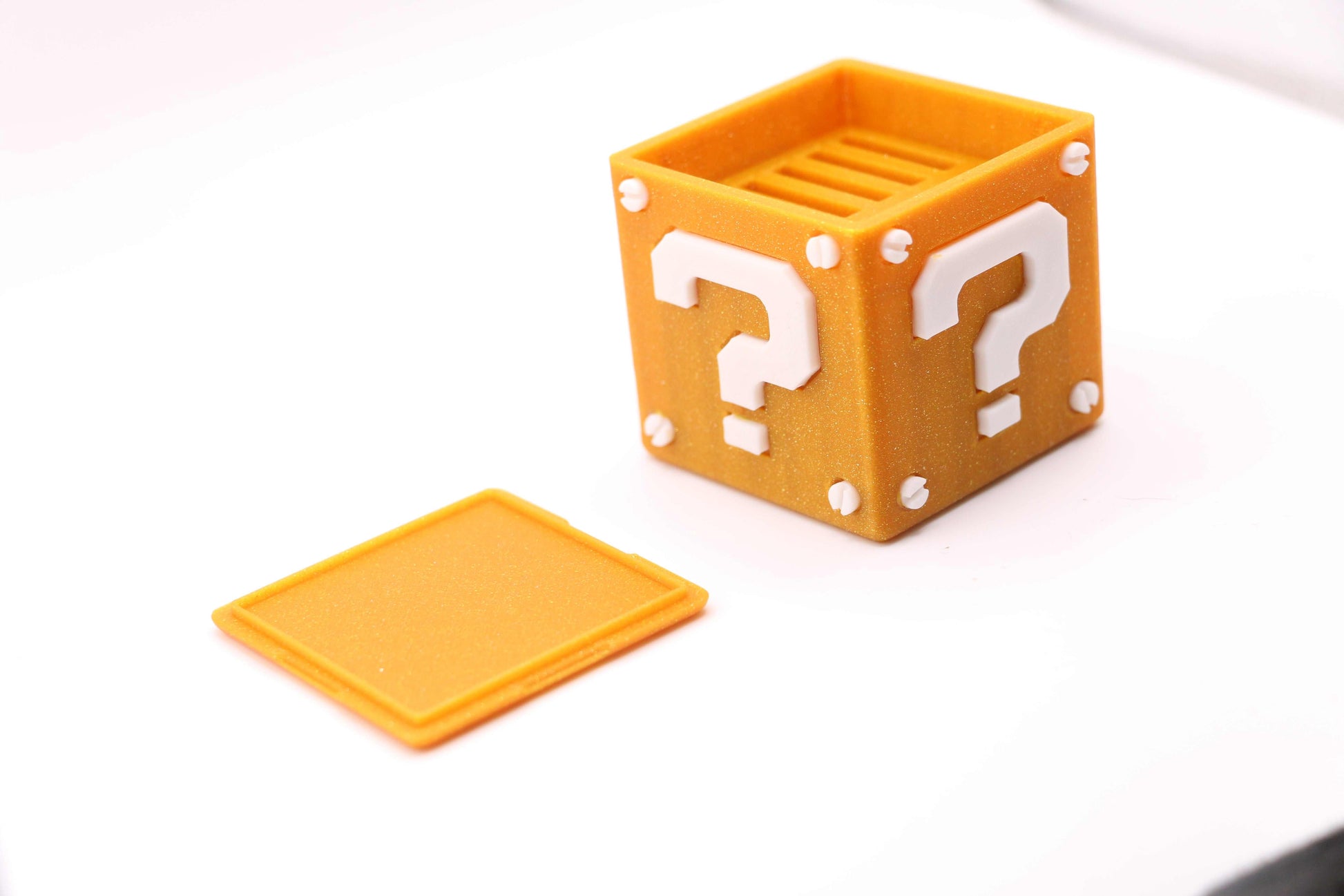 Super Mario Bros Nintendo Switch game case shaped like a Question Mark Block holding cartridges and micro SD cards