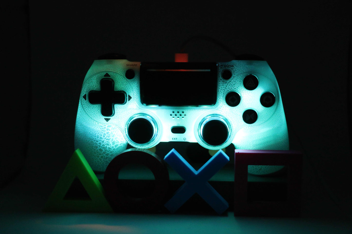 Loaded Pro LED PS4 Controller glowing blue with custom LEDs and back paddles for enhanced FPS gaming.